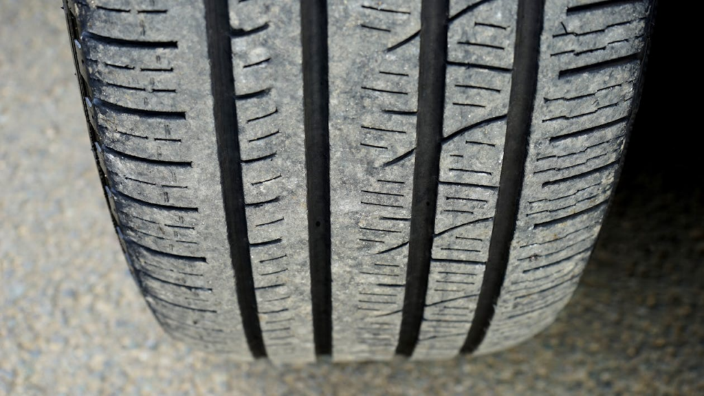 Close-up of a tire showing uneven tread wear with noticeably more wear on the inner edge