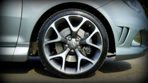 A close-up of a car's alloy wheel, tire, and brake caliper.