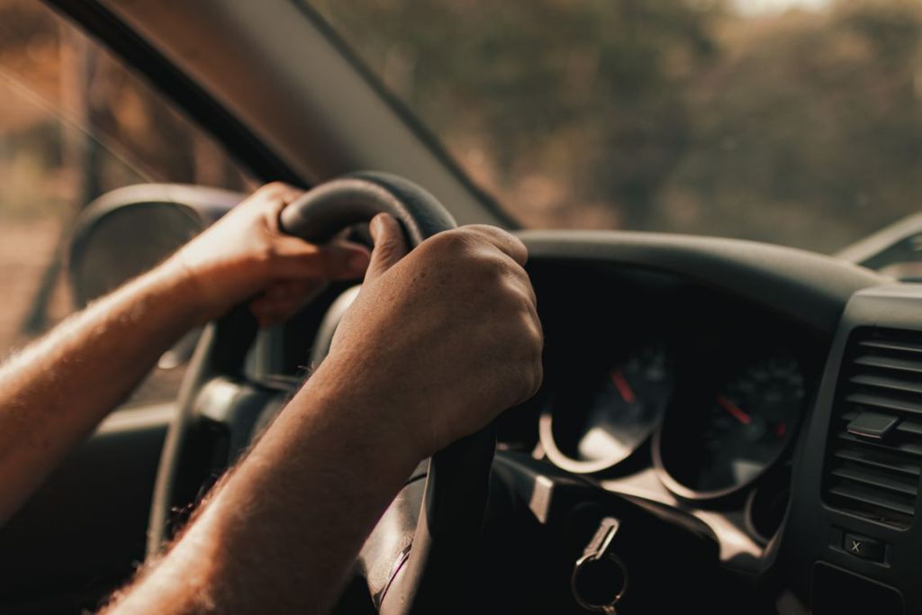Driver gripping a steering wheel