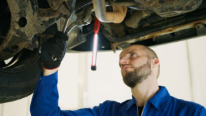 Automotive technician inspecting a vehicle