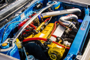 A close-up of a turbocharged engine bay with custom piping and components.