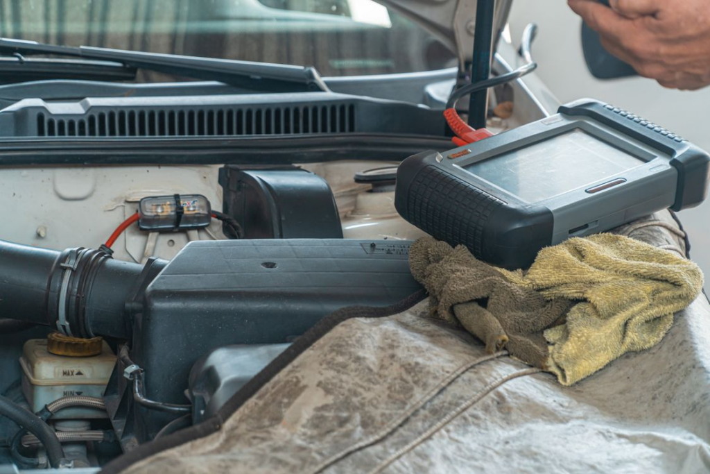Automotive technician using professional diagnostic equipment