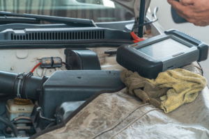 Automotive technician using professional diagnostic equipment