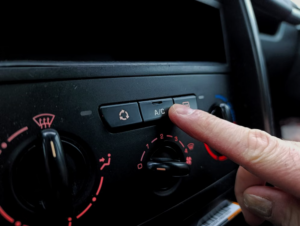 Driver adjusting the climate controls