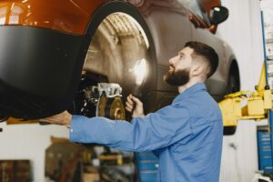 Technician inspecting brake components to evaluate rotor wear and stopping performance