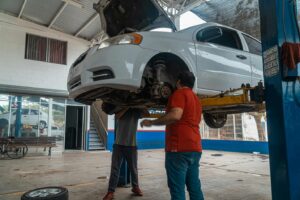 Vehicle raised in a repair shop for inspection of unusual car noises